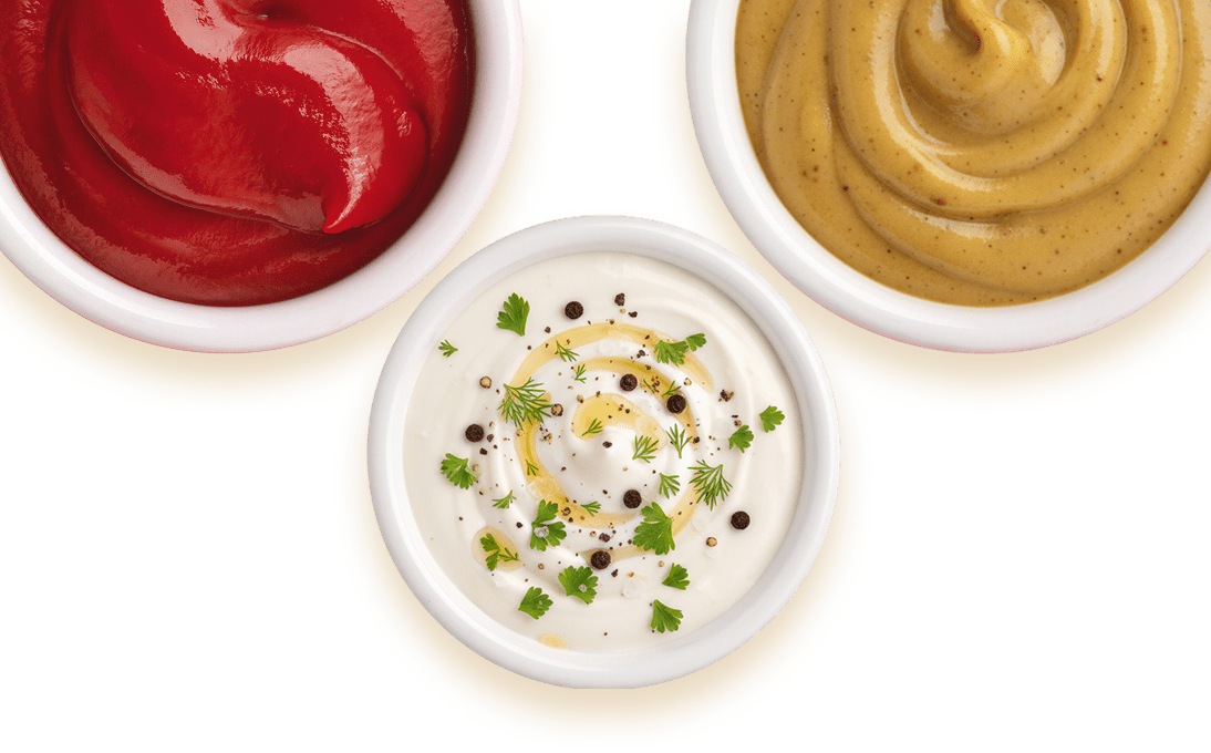 Trio of condiments on black background