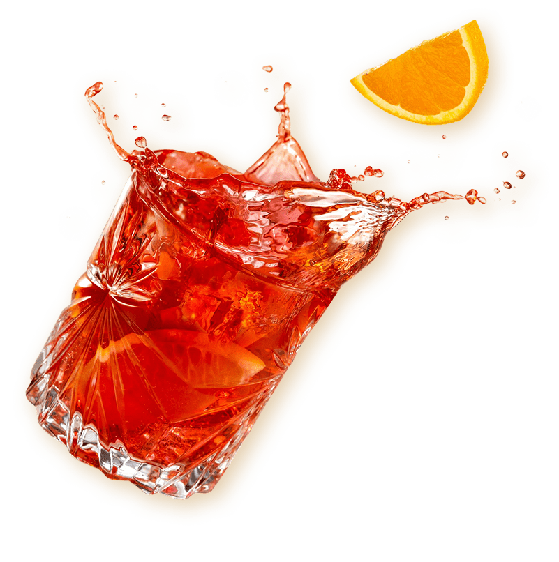 Splashing red drink with citrus garnish